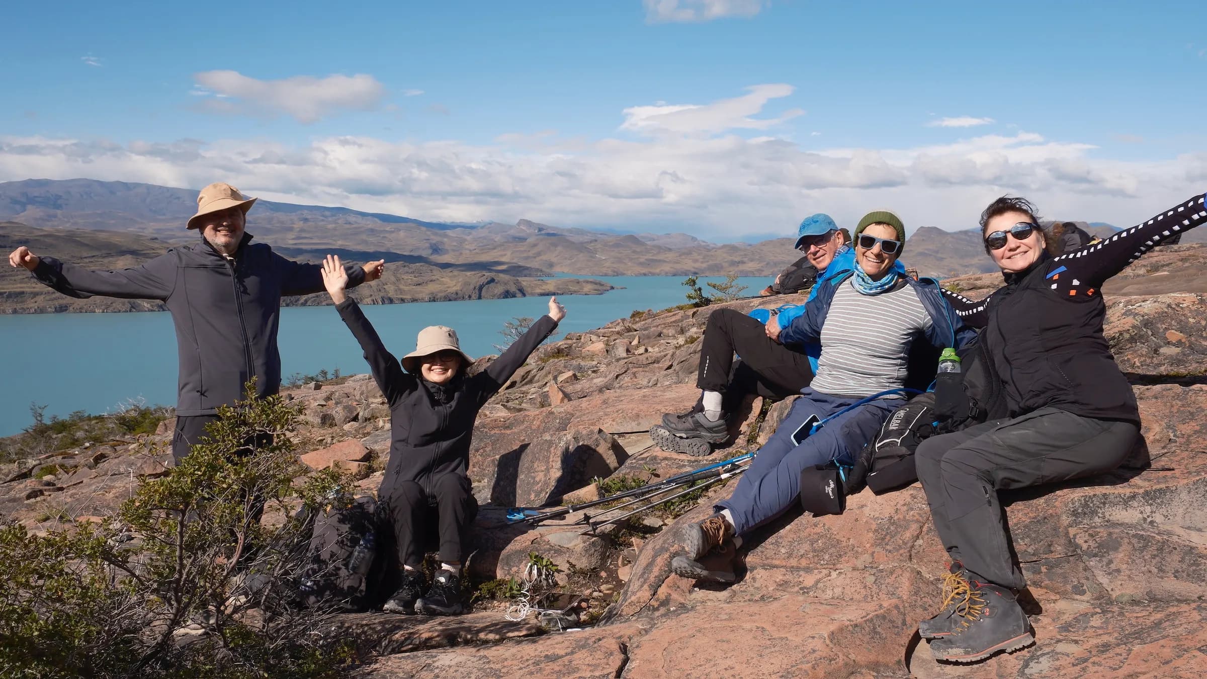 Group of hikers celebrating at a viewpoint on the Cuernos trail, Torres del Paine