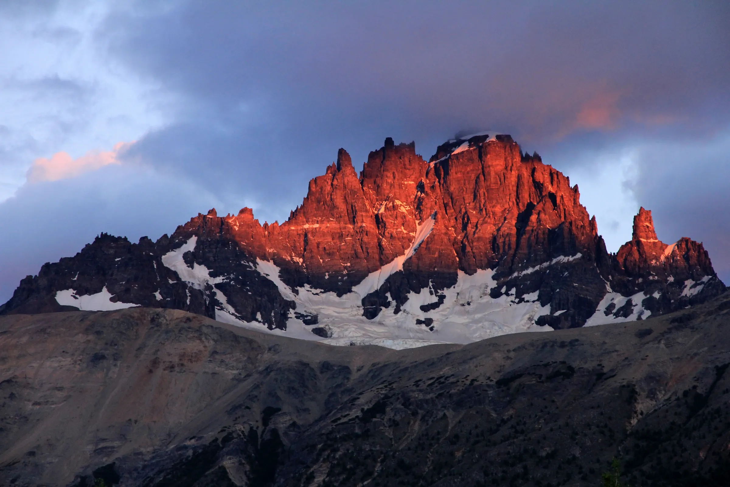 The spires of Cerro Castillo lit red at sunrise, Aysén