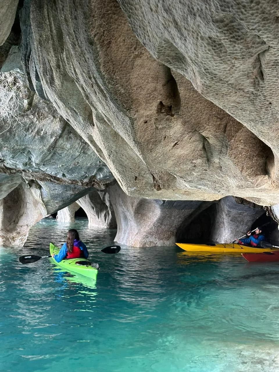 Kayakers paddling inside the Marble Caves on General Carrera Lake, Aysén